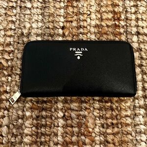 Prada Saffiano zip around black wallet with coin pouch and gold tone hardware